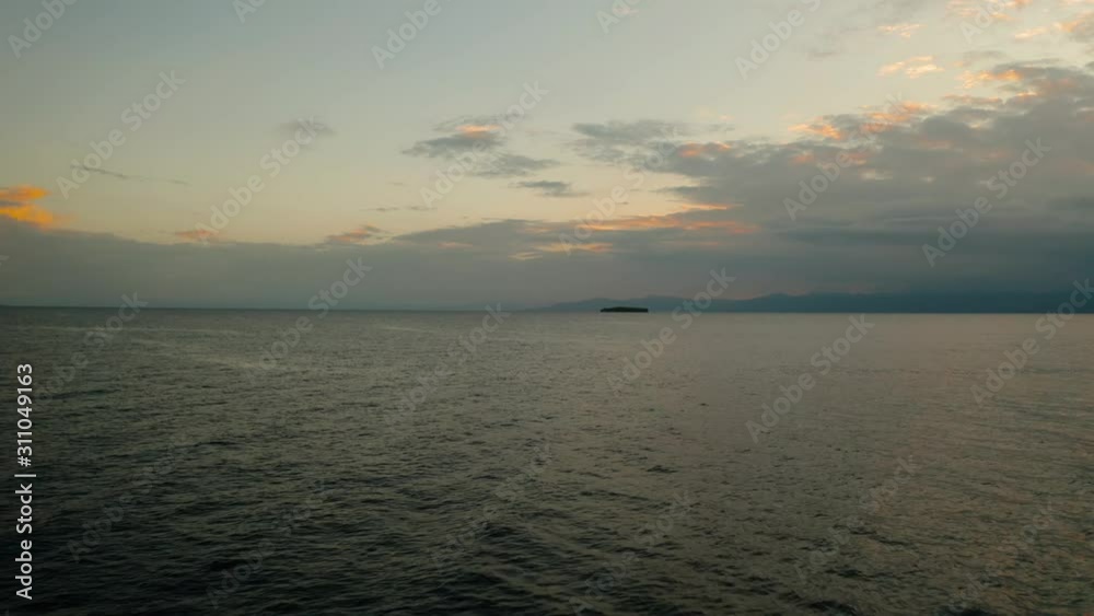 Sunset above the sea surface with waves, top view. Reflected sun on a water surface. Sunset over ocean. Seascape, Summer and travel vacation concept Sunset above the sea surface with waves, top view. Reflected sun on a water surface. Sunset over ocean. Seascape, Summer and travel vacation concept