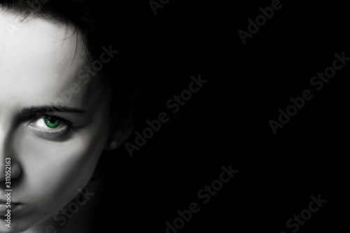 Half female face on a black background. Postcard pattern with black background