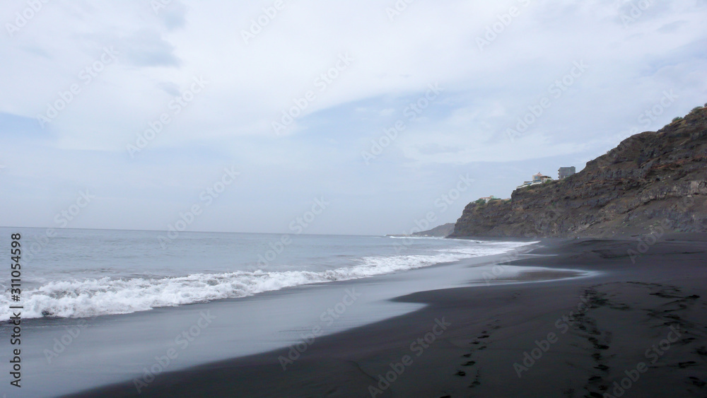 black lava sand beach and jagged wild coastline on Fogo Island in Cape Verde