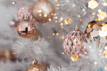 Decorated christmas tree with pink and golden toys on white background. Christmas concept, 2020.