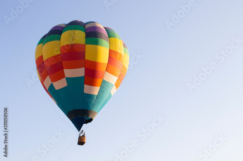 Beautiful hot air balloon against dark blue sky with basket