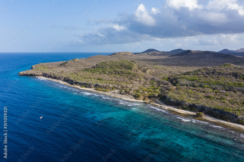 Aerial view of coast of Curaçao in the Caribbean Sea with turquoise water, cliff, beach and beautiful coral reef around Sta. Martha Bay Aerial view of coast of Curaçao in the Caribbean Sea with turquoise water, cliff, beach and beautiful coral reef around Sta. Martha Bay
