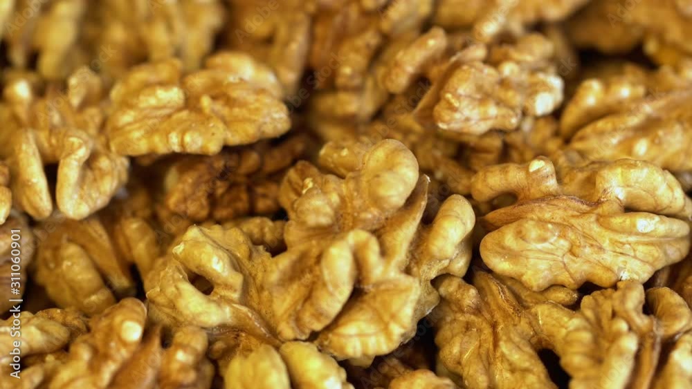 Walnut close up. product rich in minerals and vitamins. Walnut turns in a shot. Walnut kernels rotating. walnut close up lies under beams of the sun. Macro Walnut close up. product rich in minerals and vitamins. Walnut turns in a shot. Walnut kernels rotating. walnut close up lies under beams of the sun. Macro