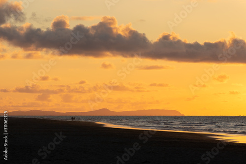 Romantic Stroll on beach at sunset