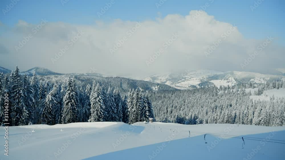 Beautiful panorama of snowy mountains landscape with snow covered forest. Christmas background with tall frozen spruce trees, winter adventure holiday and recreation Beautiful panorama of snowy mountains landscape with snow covered forest. Christmas background with tall frozen spruce trees, winter adventure holiday and recreation