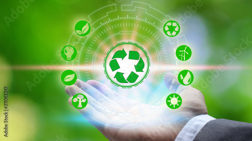 Hand holding and protection with environment icons over the Network connection on nature background, Technology ecology concept.