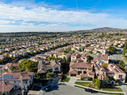 Aerial view of upper middle class neighborhood with identical residential subdivision houses during sunny day in Chula Vista, California, USA. © Unwind