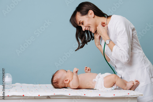 pediatrician doctor communicates and plays with baby photo