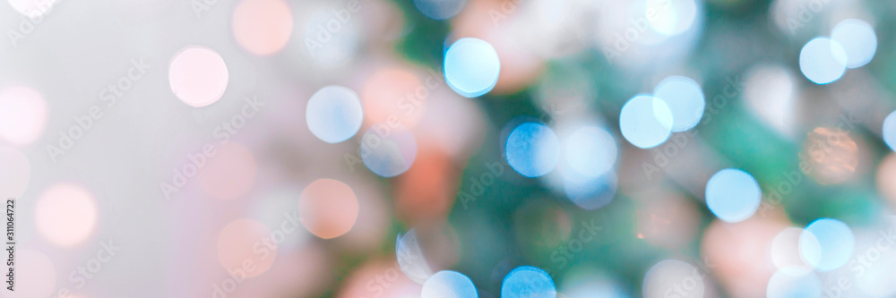 Banner made with blurred golden and blue festive lights on christmas tree. Christmas time concept.