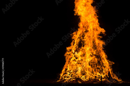 flames and fire released by a pyre for the traditional epiphany festival in Italy