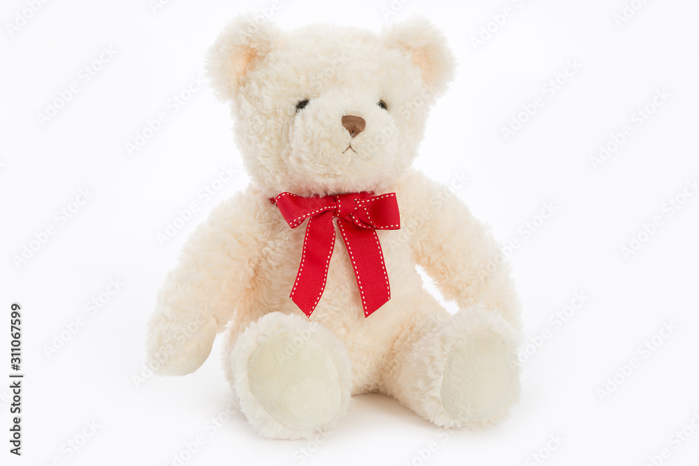 white plush fluffy Teddy bear on Valentine's day holiday sits with red satin ribbon on neck isolated on white background