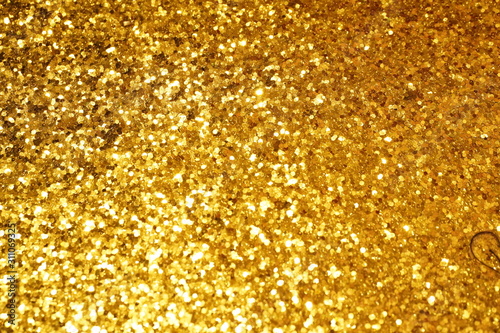 A close-up view of gold paper and the light that make a reflection. This makes an awesome effect.