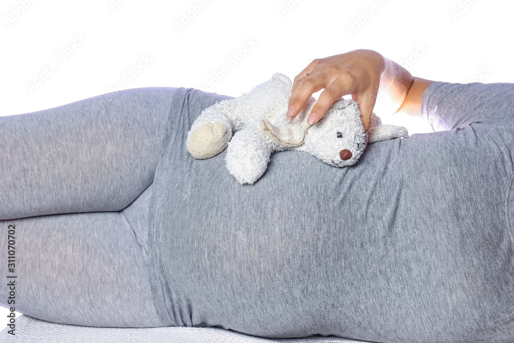 Happy pregnant girl lies on white background Happy pregnant girl lies on white background