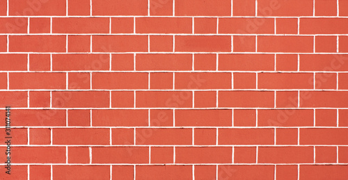 Orange brick wall, light red background of masonry, plastered texture stained blocks of stonework.