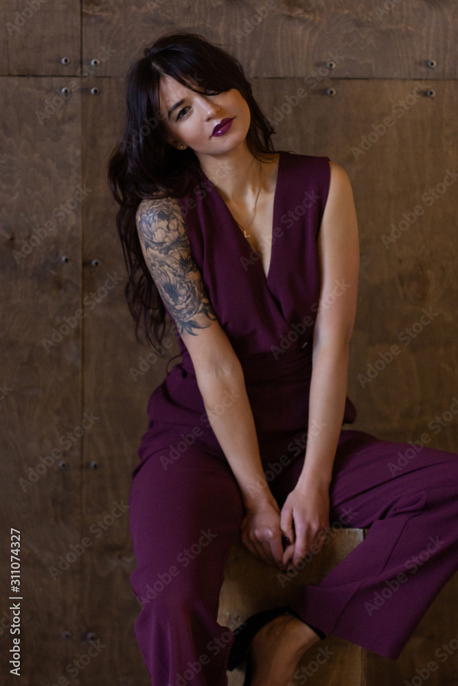 Beautiful young woman wearing marsala jumpsuit