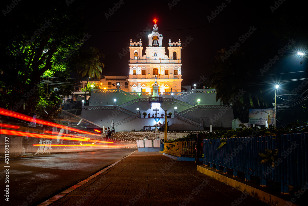 Landscape having a beautiful church in background with traffic light trails at night - obrazy, fototapety, plakaty 