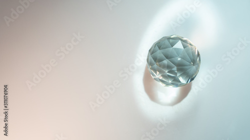 Large crystal on a white background with light refraction abstraction. A lot of space for an inscription or logo.