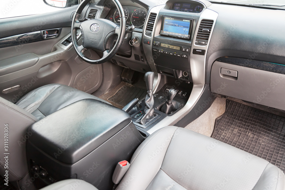 View to the gray interior of toyota Land Cruiser prado 120 with dashboard,  media system, front seats, steering and shiftgear after cleaning before  sale on parking Stock Photo | Adobe Stock