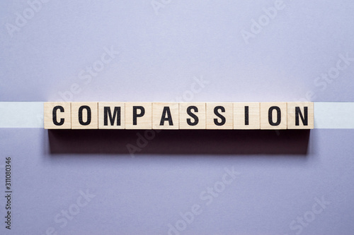 Compassion word concept on cubes photo