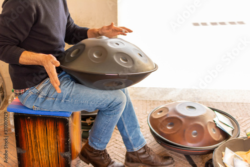 Musician Playing Handpan on Blurred Background photo