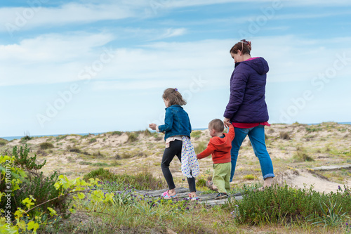 Family day out at coast sand dunes.