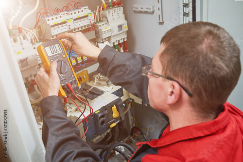 electrician measurements with multimeter tester photo