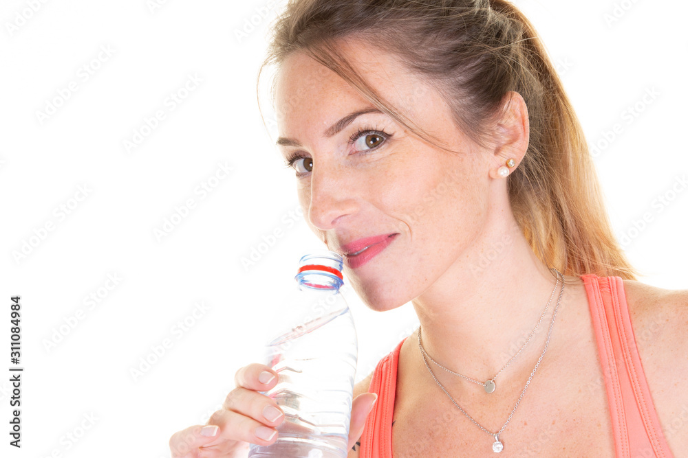woman pretty fitness model holding a water bottle in white studio background woman pretty fitness model holding a water bottle in white studio background