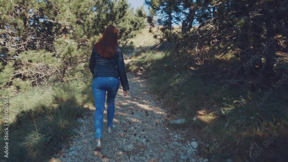 The girl rises uphill. Traveling on a mountain road. The girl rises uphill. Traveling on a mountain road.