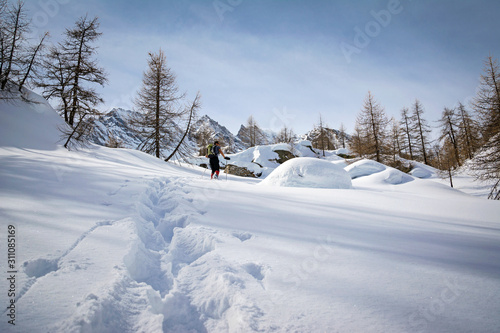 Winter landscape with mountaineer tracks in the sunshine, italian Alps © ueuaphoto