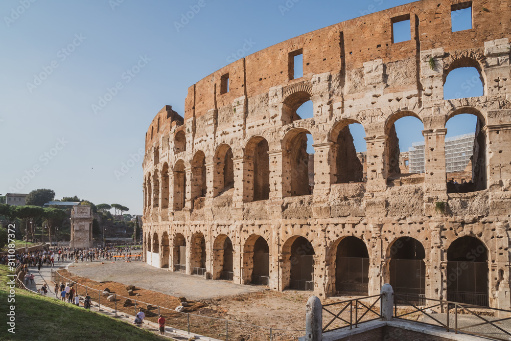 view of Rome Colosseum in Rome , Italy . The Colosseum was built in the time of Ancient Rome in the city center.