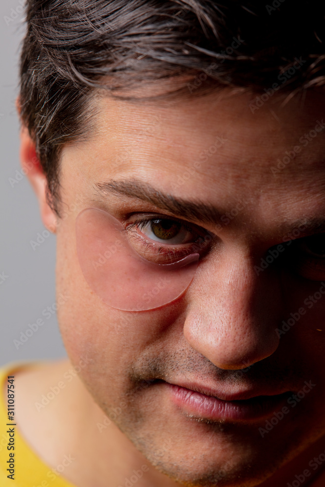 Pink eye patch on young man face Pink eye patch on young man face