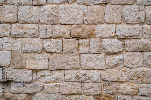Gray old stone wall background. yellow rock wall made of stone.