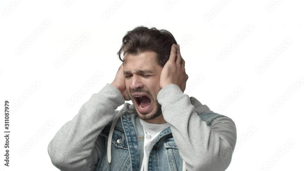 Slow-motion distressed and scared bearded man standing indecisive, dont know what do, grab head, shut ears and screaming shaking sideways, feel panic and anxiety, standing depressed white background Slow-motion distressed and scared bearded man standing indecisive, dont know what do, grab head, shut ears and screaming shaking sideways, feel panic and anxiety, standing depressed white background