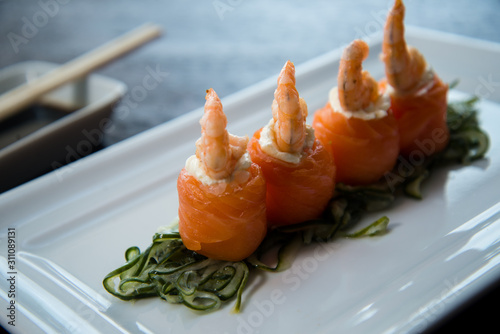 salmon cucumber and cream cheese shrimp sushi in a white plate shoyo and chopstick sauce, asian food, japanese cuisine photo