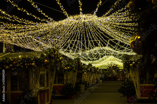 Christmas fair without people in Moscow with illumination against the night sky