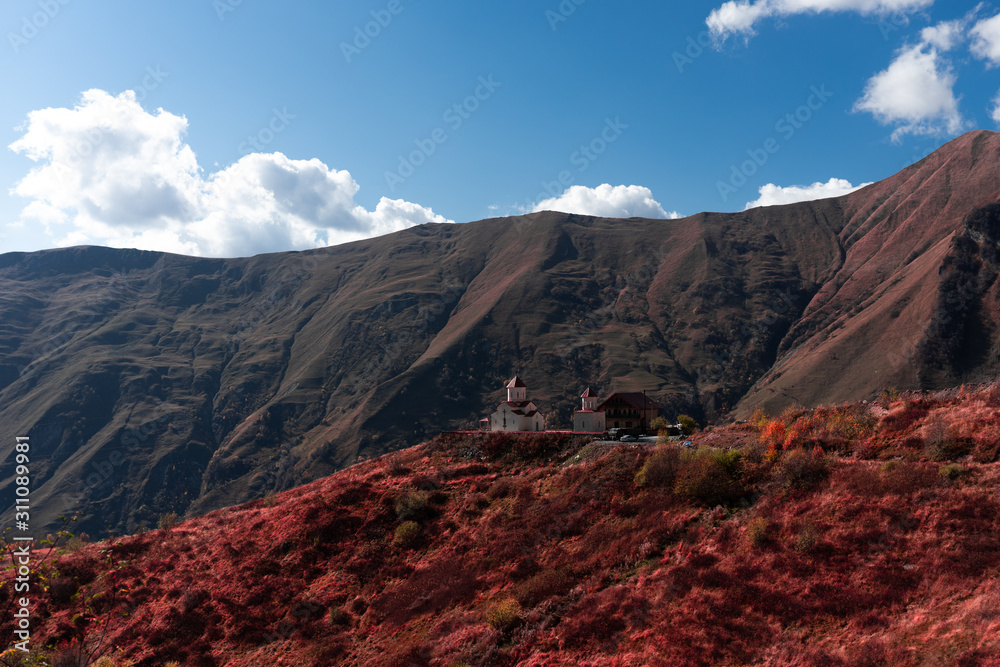 A panoramic view of Mount Kazbegi is a sleeping stratovolcano and one of the main mountains of the Caucasus, located on the border of the Kazbegi region of Georgia. In lush lava color. Design and crea