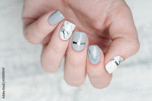 white grey marble manicure with silver stripe on grey background