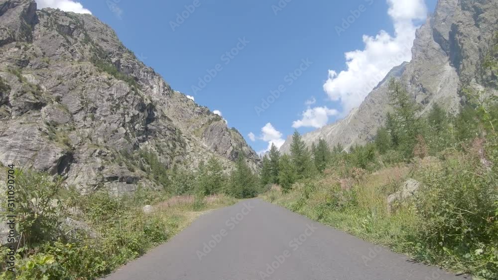 Vehicle point of view shot while driving on the road climbing to the base of the climbing route to the Glacier Blanc in Ecrins Massif in Hautes Alpes in France. Vehicle point of view shot while driving on the road climbing to the base of the climbing route to the Glacier Blanc in Ecrins Massif in Hautes Alpes in France.