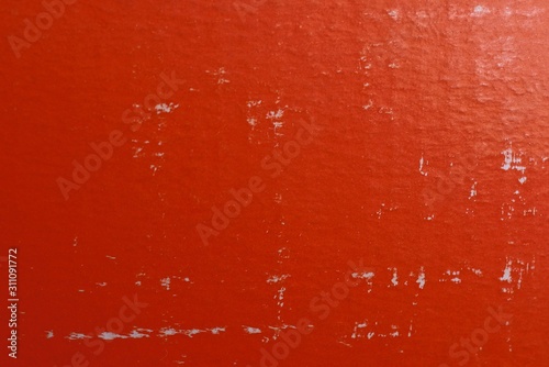 red paper texture with white scuffs on an old piece of cardboard