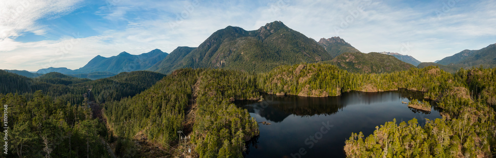 Fototapeta premium Beautiful Aerial Panoramic View of Larry Lake during a vibrant sunny day. Located on the West Coast of Vancouver Island near Tofino and Ucluelet, British Columbia, Canada.