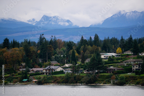 Campbell River, Vancouver Island, British Columbia, Canada. Beautiful view of residential homes on the ocean shore during a cloudy evening. © edb3_16