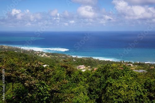 Beautiful View of the Caribbean Sea from top of a hill during a sunny and cloudy day. Church View, Saint John, Barbados.
