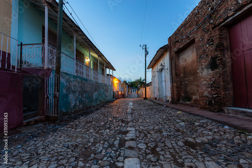 Trinidad, Cuba. Street view of a Residential neighborhood in a small Cuban Town during a cloudy and sunny sunrise.