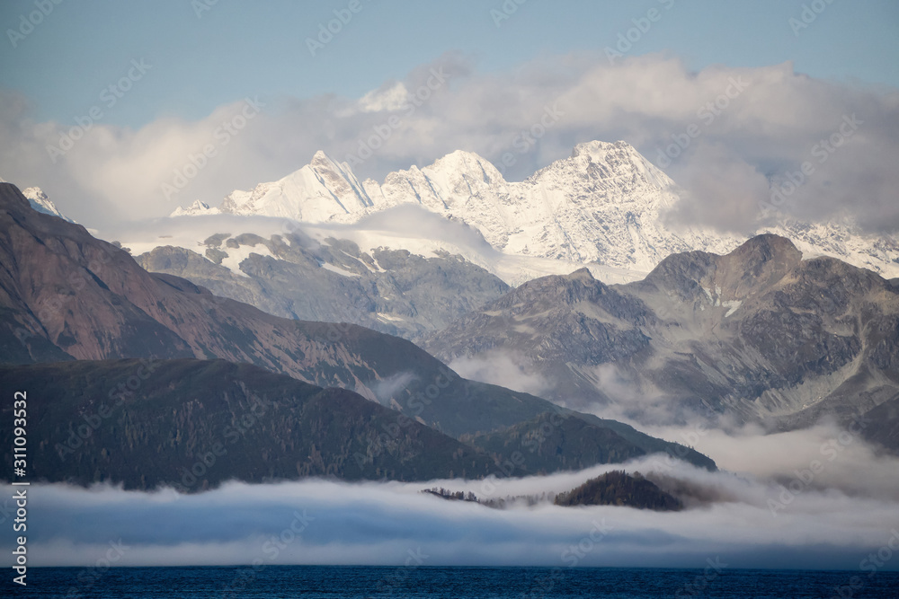 Beautiful View of American Mountain Landscape on the Ocean Coast during a cloudy and colorful sunrise in fall season. Taken in Glacier Bay National Park and Preserve, Alaska, USA.
