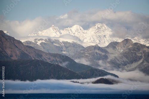 Beautiful View of American Mountain Landscape on the Ocean Coast during a cloudy and colorful sunrise in fall season. Taken in Glacier Bay National Park and Preserve, Alaska, USA.