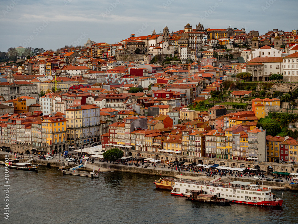 Porto, Portugal. 16 November 2019. Colorful skyline of the old town at sunset seen from other side of river Douro.