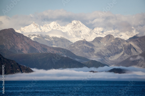 Beautiful View of American Mountain Landscape on the Ocean Coast during a cloudy and colorful sunrise in fall season. Taken in Glacier Bay National Park and Preserve, Alaska, USA.