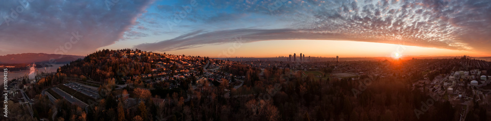 Aerial Panoramic View of a modern city during a colorful and cloudy sunset. Taken in Burnaby, Greater Vancouver, British Columbia, Canada.