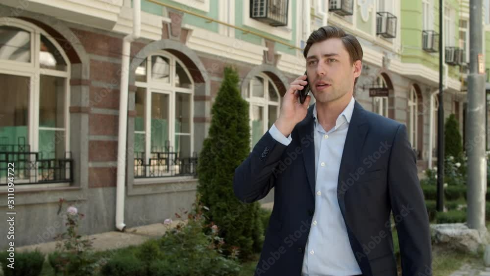 Business man talking phone at street. Businessman discussing business outdoor Business man talking phone at street. Businessman discussing business outdoor