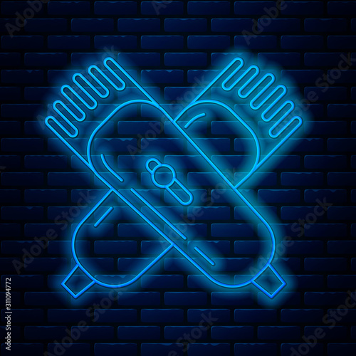 Glowing neon line Crossed electrical hair clipper or shaver icon isolated on brick wall background. Barbershop symbol. Vector Illustration